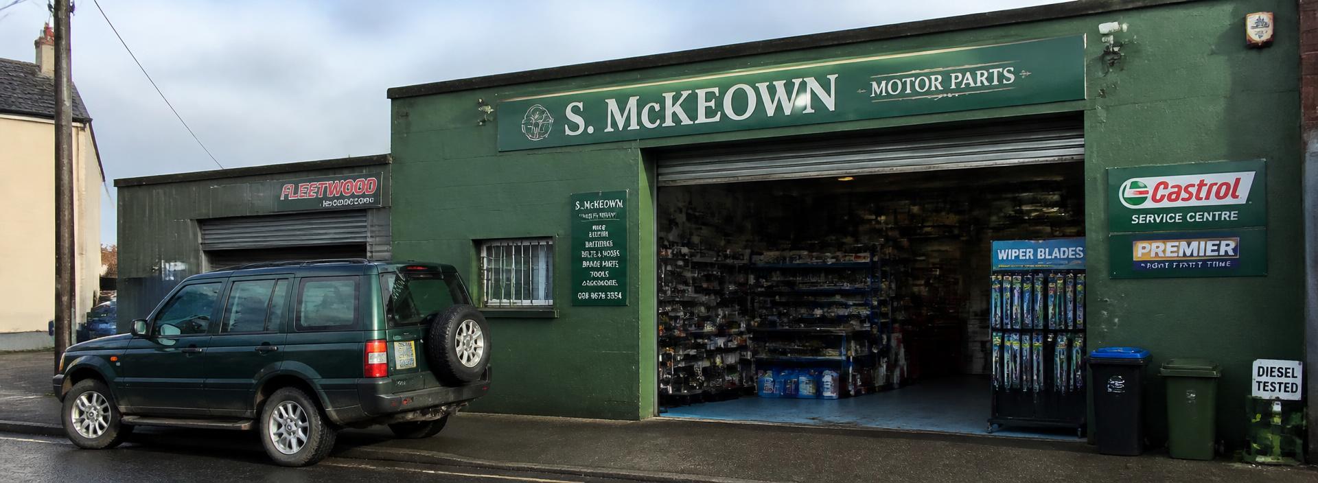 Green-fronted motor parts shop with the shutter open
